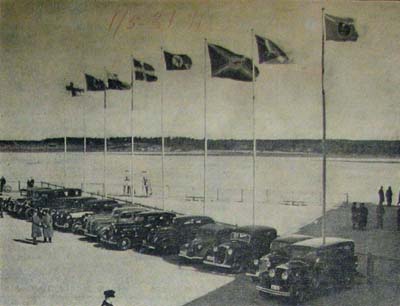 Aero ja ABA saivat seuraa huhtikuun lopussa. Neljän lentoyhtiön ja valtion liput liehuivat Malmilla LOTin ja Lufthansan aloitettua reittiliikenteen Suomeen. Kuva on julkaistu Helsingin Sanomissa 1.5.1937.